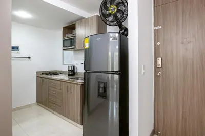 a kitchen with a stainless steel refrigerator in at Mirador Verde by MOME in Medellín