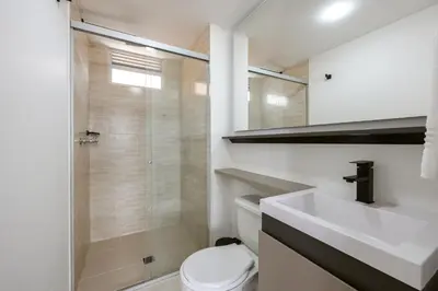 a bathroom with a toilet and a sink and a shower at Mirador Verde by MOME in Medellín