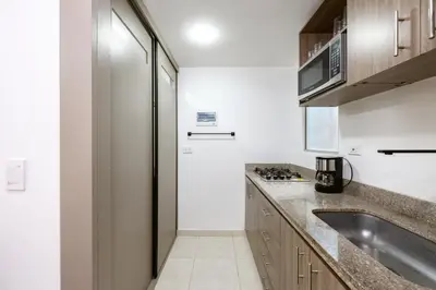 a kitchen with a sink and a refrigerator at Mirador Verde by MOME in Medellín