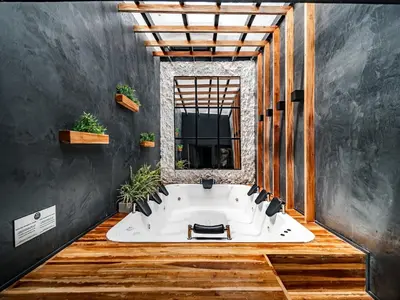 a large bath tub in a room with a window at One Apartments Lleras in Medellín