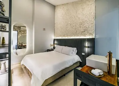 a bedroom with a large bed and a sink at One Apartments Lleras in Medellín