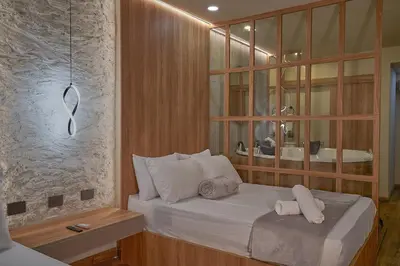 a bedroom with a bed with two towels on it at One Apartments Lleras in Medellín