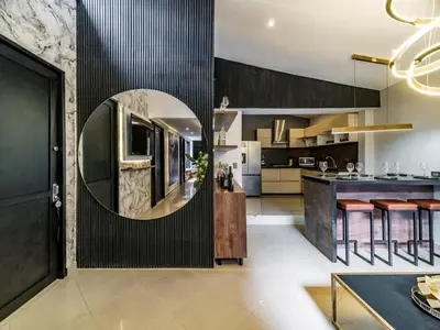 a kitchen with a round mirror on the wall at One Apartments Lleras in Medellín