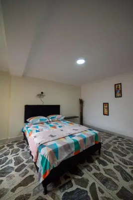 a bedroom with a large bed in a room at Your home away from home in Medellín