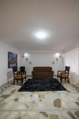 a living room with a couch and two chairs at Your home away from home in Medellín