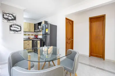 a dining room with a glass table and chairs at Parque de Envigado a 350 mts, 2bd, 500mb internet in Envigado