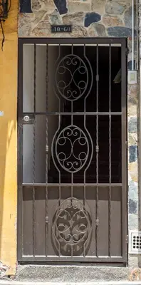 a door with a metal gate on a building at Parque de Envigado a 350 mts, 2bd, 500mb internet in Envigado