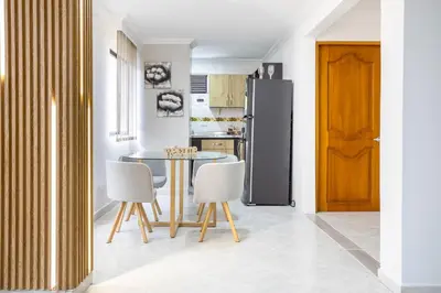 a kitchen with a table and chairs and a refrigerator at Parque de Envigado a 350 mts, 2bd, 500mb internet in Envigado