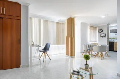 a living room with a table and chairs at Parque de Envigado a 350 mts, 2bd, 500mb internet in Envigado