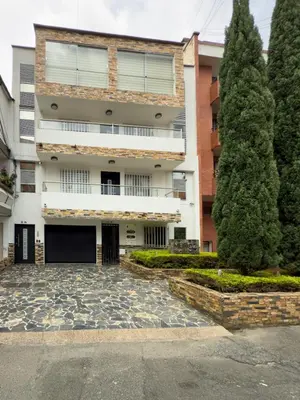 an apartment building with a courtyard and trees at Belén Vibe in Medellín