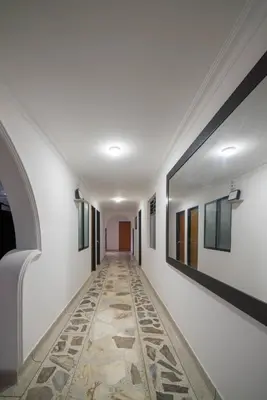 a corridor with a tile floor in a hallway at Belén Vibe in Medellín