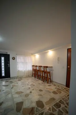 a dining room with chairs and a table in a room at Belén Vibe in Medellín