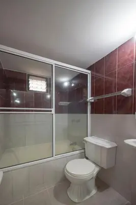 a bathroom with a toilet and a shower and a sink at Belén Vibe in Medellín