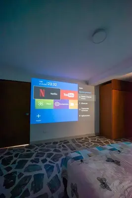 a bedroom with a large screen on the wall at Belén Vibe in Medellín