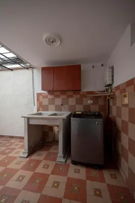 a kitchen with a table and a refrigerator at Belén Vibe in Medellín
