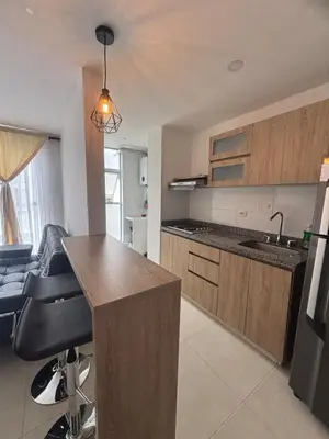 a kitchen with a counter and a kitchen island in it at Acogedor y moderno apartamento en Manizales in Manizales