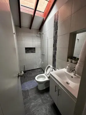 a bathroom with a toilet and a sink at Apartamento cerca al metro y viva envigado in Itagüí