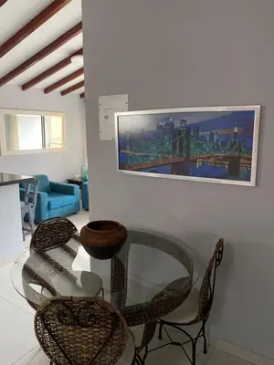 a living room with a glass table and chairs at Apartamento cerca al metro y viva envigado in Itagüí