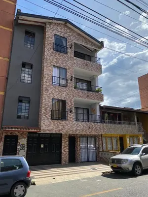 a building with cars parked in front of it at Apartamento cerca al metro y viva envigado in Itagüí