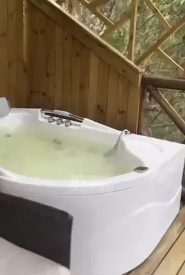 a white tub sitting on top of a wooden floor at Chalet los naranjos in La Pradera