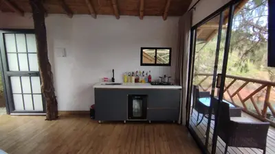 a room with a fireplace in the middle of a house at Chalet los naranjos in La Pradera