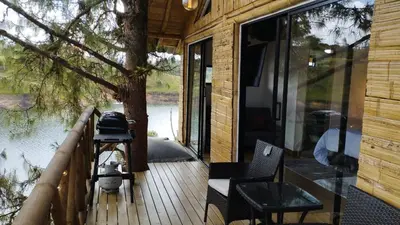 a porch of a cabin with a view of the water at Chalet los naranjos in La Pradera