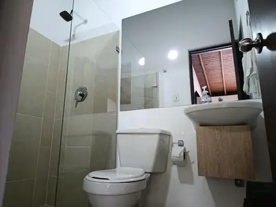 a bathroom with a toilet and a sink and a shower at Cloud9h in Medellín