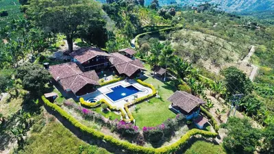an aerial view of a house with a swimming pool at Finca Doña Ana in Palestina
