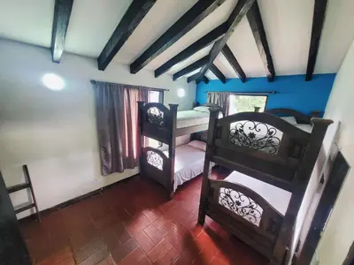 a bedroom with two bunk beds in a room at Finca Doña Ana in Palestina
