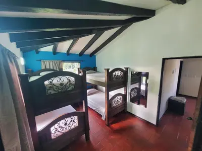 two bunk beds in a room with a ceiling at Finca Doña Ana in Palestina
