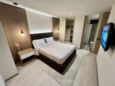 a bedroom with a bed and a television in it at Designed 3-Bedroom Apartment & Office with 800 Wi-Fi, New Samsung Appliances in Envigado