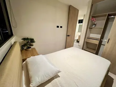 a small room with a bed and a door at Designed 3-Bedroom Apartment & Office with 800 Wi-Fi, New Samsung Appliances in Envigado