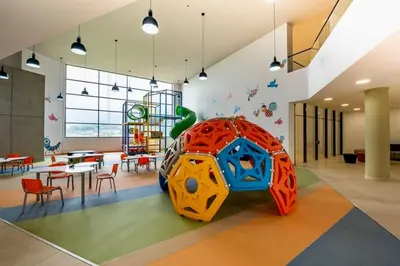 a room with a playground with a table and chairs at Designed 3-Bedroom Apartment & Office with 800 Wi-Fi, New Samsung Appliances in Envigado