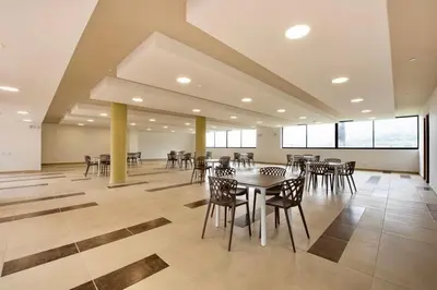 a large room with tables and chairs and windows at Designed 3-Bedroom Apartment & Office with 800 Wi-Fi, New Samsung Appliances in Envigado