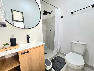 a bathroom with a toilet and a sink and a mirror at Rincon del Parque, Jerico - 2 Hab - 2 Cama Tarima - 1 Baño in Jericó