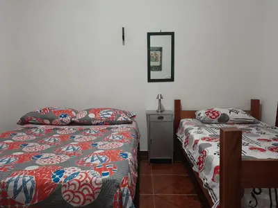 a bedroom with two beds and a table in it at Mirador del Río in Honda