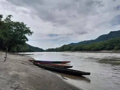 a group of boats sitting on the shore of a river at Mirador del Río in Honda