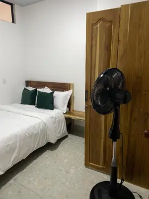 a bedroom with a fan next to a bed at Casa Selva in San Carlos