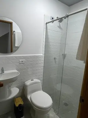 a bathroom with a toilet and a glass shower at Casa Selva in San Carlos