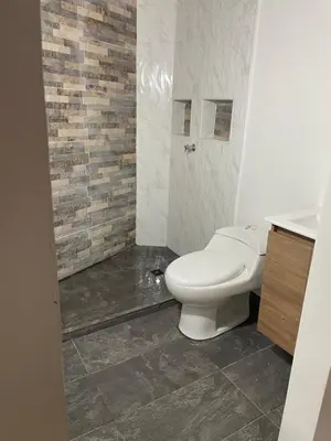 a bathroom with a white toilet and a sink at Villa Paulina in Ebéjico