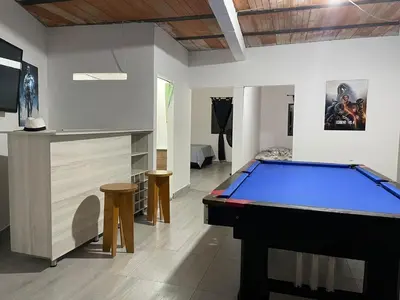 a room with a pool table and a tv at Villa Paulina in Ebéjico
