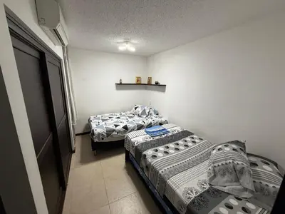 two beds in a room with two beds sidx sidx sidx at Ciudadela Santafé De Antioquia in Santa Fe de Antioquia