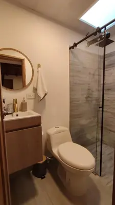 a bathroom with a toilet and a sink and a shower at Acogedor mini apartamento in Sonsón
