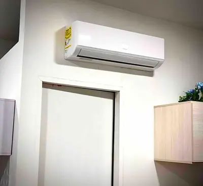 a white air conditioner on a wall next to a door at AC Laureles Fast Internet for Nomads 5 Floor in Medellín