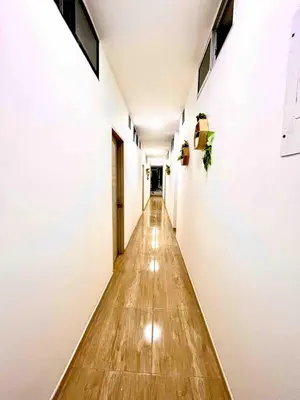 a long hallway with white walls and a wooden floor at AC Laureles Fast Internet for Nomads 5 Floor in Medellín