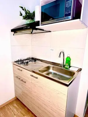 a kitchen with a sink and a microwave at AC Laureles Fast Internet for Nomads 5 Floor in Medellín