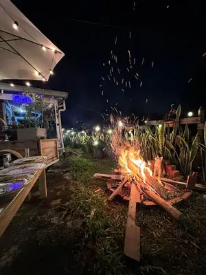 a fire pit in the yard at night at SELENE Hostal Coworking Café in Medellín