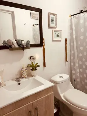a bathroom with a sink and a toilet and a mirror at SELENE Hostal Coworking Café in Medellín