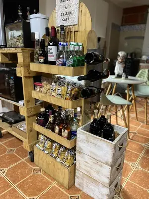 a shelf with bottles of wine on it at SELENE Hostal Coworking Café in Medellín