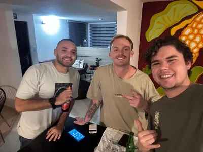 a group of three men posing for a picture at Hostal Galería de la Montaña, Medellin in Estación El Salto
